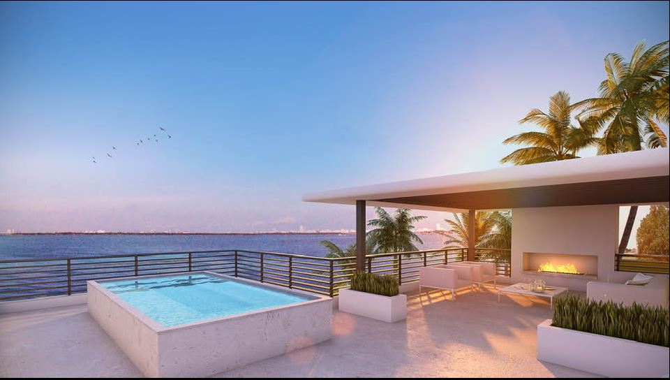 Luxury Florida pool house with natural pool deck stone pavers surrounding a tropical backyard swimming pool