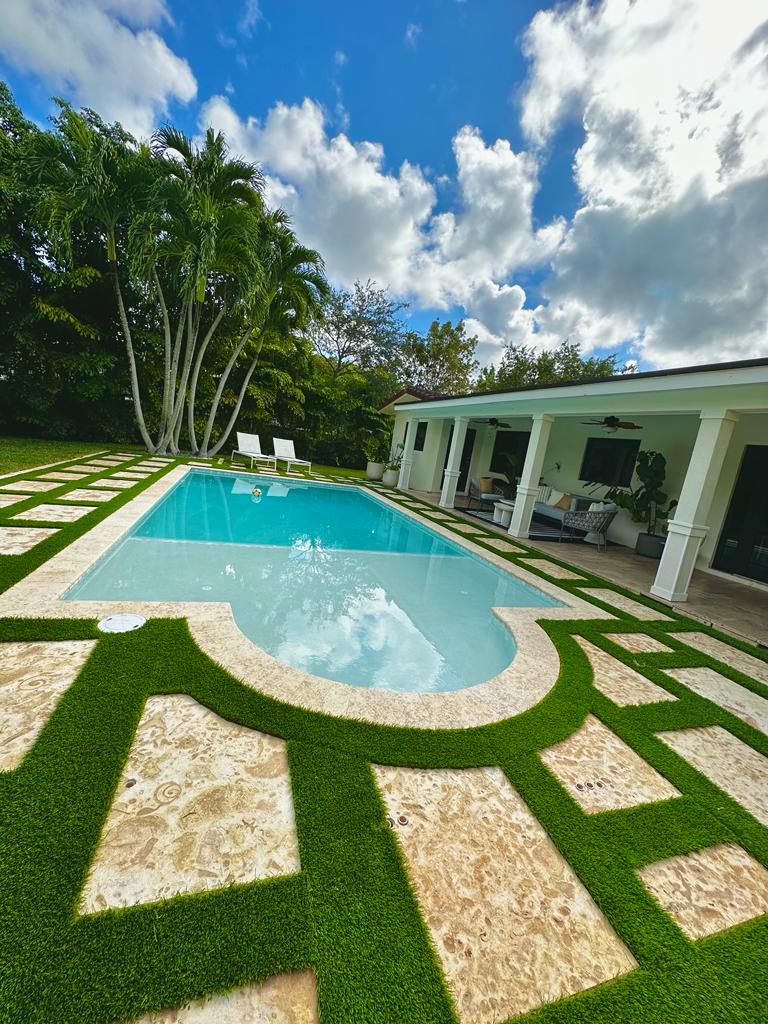 Stepping stones pool deck pavers with grass joints in a modern luxury outdoor swimming pool design
