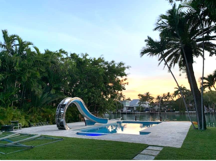 Coral stone pool deck stone in a luxury backyard pool designed for hot climates