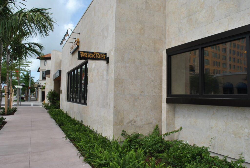 Restaurant exterior finished with filled and honed coral stone wall cladding creating a clean elegant natural stone facade